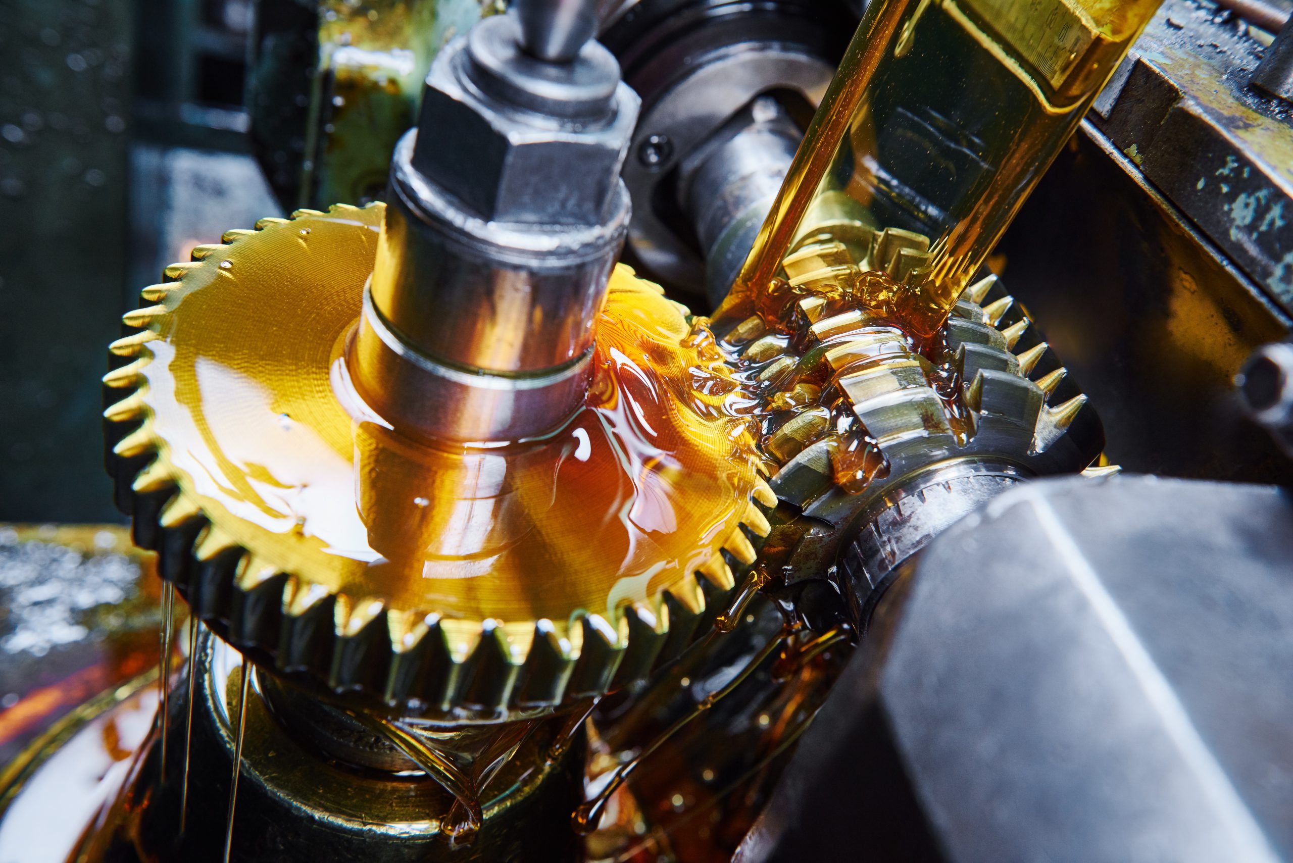 Lubrication oil poured onto a machines gears